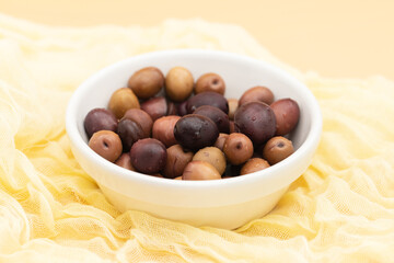 many salted mixed olives in white bowl