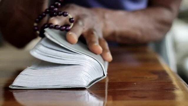 man praying to God with hand on bible with people stock video stock footage