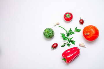 Creative composition of pumpkin, eggplant, bell pepper, sherry tomatoes, garlic and zucchini on a white background. Food concept. Healthy food. View from above.