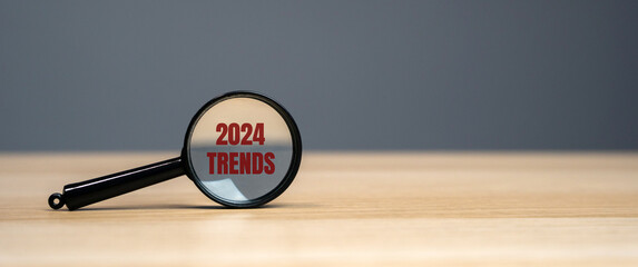 Magnifying glass with the inscription Trends 2024. The concept of searching for new ideological trends and tendencies. Exclusive trend. Popular and relevant topics.