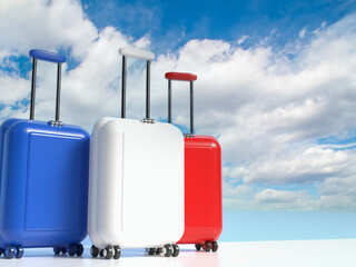 Travel suitcases in the colors of the flag of France against the sky with clouds with empty space for text. 3d illustration on the theme of business trips. © Николай Батаев