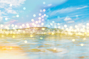 Fototapeta na wymiar Panorama of a calm sea with clouds on the horizon. Background on the theme of summer vacation and ecology. Crystal clear ocean water with bright splashes and bokeh.