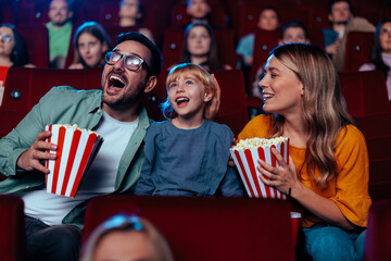 Excited family in movie theater.