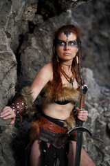 Beautiful female viking woman warrior with sword. Red amazon fantasy