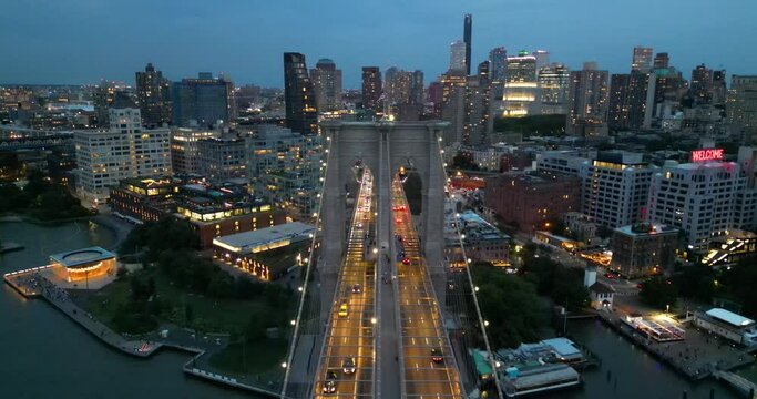 Flight over Brooklyn Bridge at dusk, New York City, USA