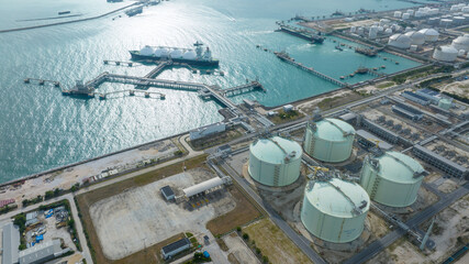 LNG (Liquified Natural Gas) tanker anchored in Gas terminal gas tanks for storage. Oil Crude Gas Tanker Ship. LPG at Tanker Bay Petroleum Chemical or Methane freighter export import transportation