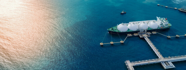 LNG (Liquified Natural Gas) tanker anchored in Gas terminal gas tanks for storage. Oil Crude Gas Tanker Ship. LPG at Tanker Bay Petroleum Chemical or Methane freighter export import transportation - obrazy, fototapety, plakaty