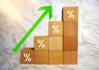 Business investment growth from dividend concept with wooden blocks with arrow up and percentage...