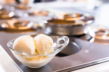 ice cream balls with a glass dessert bowl on the table in the ice cream display case