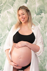 Young pregnant woman in studio lighting
