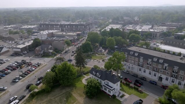 Downtown Plymouth, Michigan with drone video moving up.