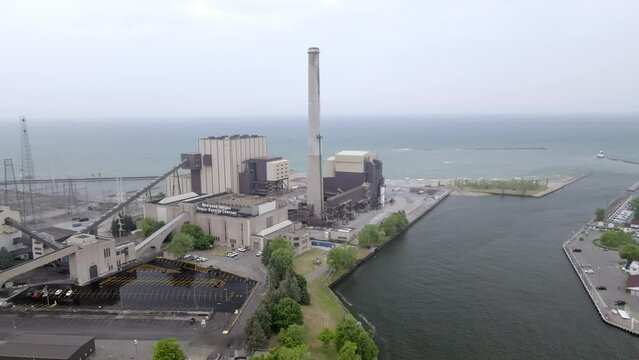 Power generating plant along Lake, Michigan in Michigan City, Indiana with drone video moving sideways.