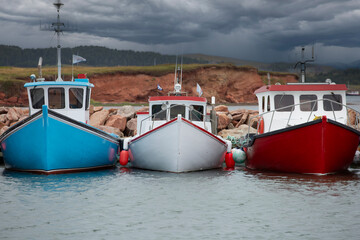 Colorful  fishing boats moored at the pier in Havre Aubert in Quebec, Canada - 617016839