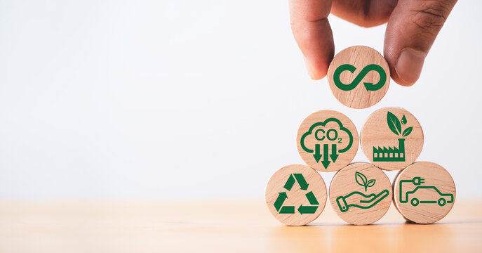 Infinity symbol with Circular business economy environment icons on wooden block cube for future sustainable investment growth and reduce environmental pollution for future concept.