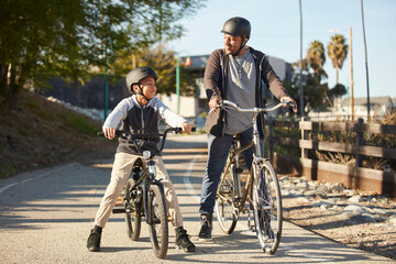 Father and son (12-13) riding bicycles