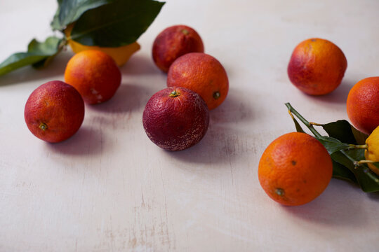 Whole blood oranges on table