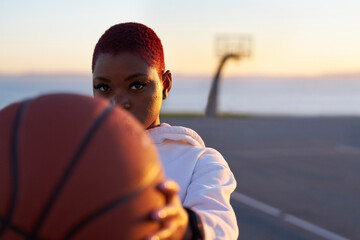Portrait of mid adult woman holding basketball