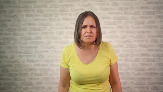 Mature woman having problem with eye blur vison. Attractive female with eyesight problems trying to read something in front of her. 4k video footage.
