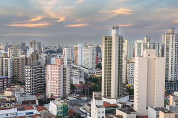 Fototapeta premium Campinas, Sao Paulo, Brazil. June 23, 2023. Aerial image of three central districts of Campinas: Vila Itapura, Cambuí and Jardim Guanabara. Sunset and blue sky.