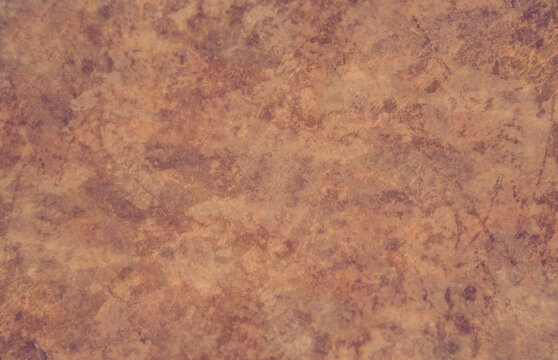 An old textured brown floor with a pattern and copy space. Background texture light rough textured spotted blank.