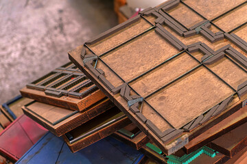 Old paper cutting molds Old Dye punching paper mold template in wood. Packaging production die...