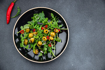 fresh green salad olive, chili pepper, green mix lettuce, arugula meal food snack on the table copy space food background rustic top view