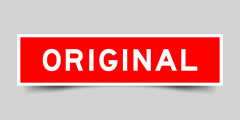 Red color square label sticker with word original on gray background