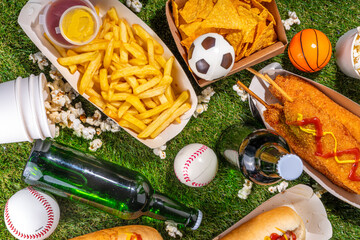 Fototapeta na wymiar Traditional sport stadium foods and beer background, Set of various baseball, basketball, football fans and stadium snacks, chips, sauces, hot dogs with beer bottles and fan accessories 