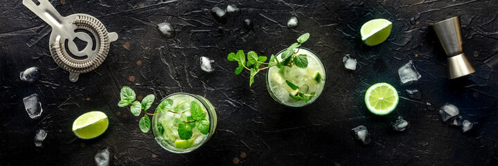 Mojito cocktail panorama. Summer cold drink with lime, fresh mint, and ice. Cool beverage on a...