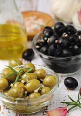 Black and green olives in glass bowls	