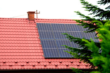 Installing a Solar Cell on a Roof. Solar panels on roof. Historic farm house with modern solar panels on roof and wall. High quality photo