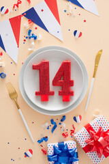 Patriotic table centerpiece for Bastille Day. Top view photo of plates, cutlery, number 14 candle,...