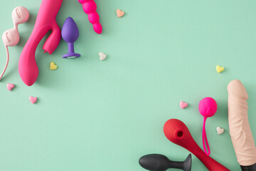 Theme of adult-oriented pleasure toys. Top view shot of vibrator, dildo, anal plugs, vaginal balls,...