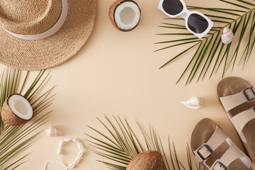 Beach holiday concept for the summer. Top view of sandals, straw hat, sunglasses, ripe coconuts, tropical leaves, seashells on pastel beige background with blank space for promo or text