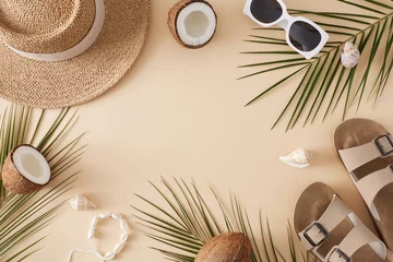 Fototapete Badezimmer Beach holiday concept for the summer. Top view of sandals, straw hat, sunglasses, ripe coconuts, tropical leaves, seashells on pastel beige background with blank space for promo or text  © Goncharuk film