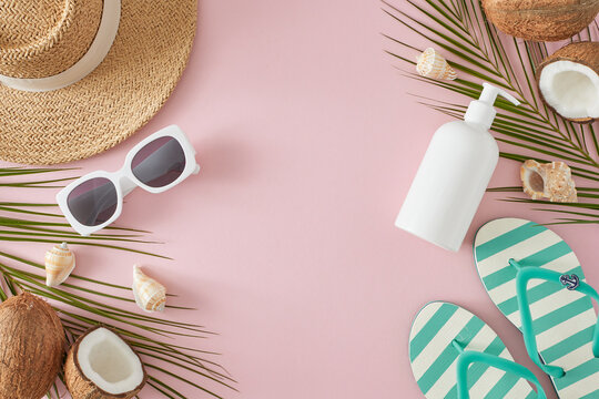 The concept of summer voyage. Top view of sunscreen bottle, flip-flops, sun hat, sunglasses, ripe coconuts, palm leaves, seashells on pastel beige background with blank space for ads or text