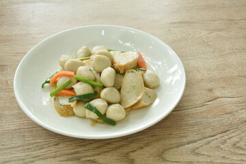 fried slice fish line and ball with carrot on plate 