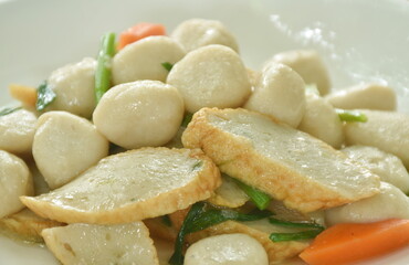 fried slice fish line and ball with carrot on plate 