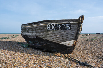 Old wooden fishing boat on a beach