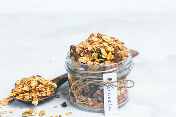 Granola with raisins and pumpkin seeds in a jar