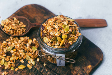 Granola with raisins and pumpkin seeds in a jar - Powered by Adobe
