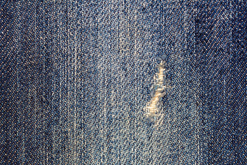close-up of worn and torn denim effect texture