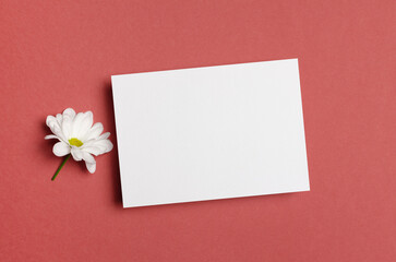 Blank paper card mockup with white flower, invitation or greeting card mock up with copy space