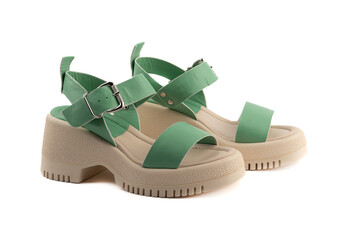 Women's summer sandals with green straps and metal fasteners.