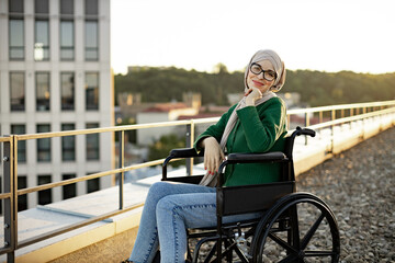 Portrait of cheerful young female with disability smiling at camera while diversifying daily...