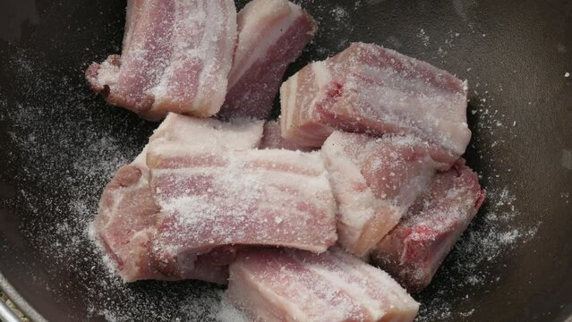 pork ribs in a cauldron of adding spices