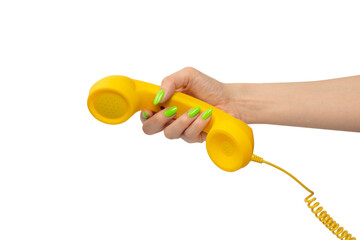 Yellow handset in woman hand with green nails isolated on a white background. - obrazy, fototapety, plakaty