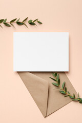 Invitation or greeting card mockup with envelope and eucalyptus twigs, blank mockup with copy space
