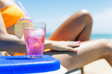  The concept of relaxing on the beacha pink cocktail close-up on the beach,