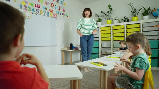 In the first grade studies are conducted at desks with the teacher. Pupils actively interact with the teacher, answer questions, perform tasks. High quality 4k footage